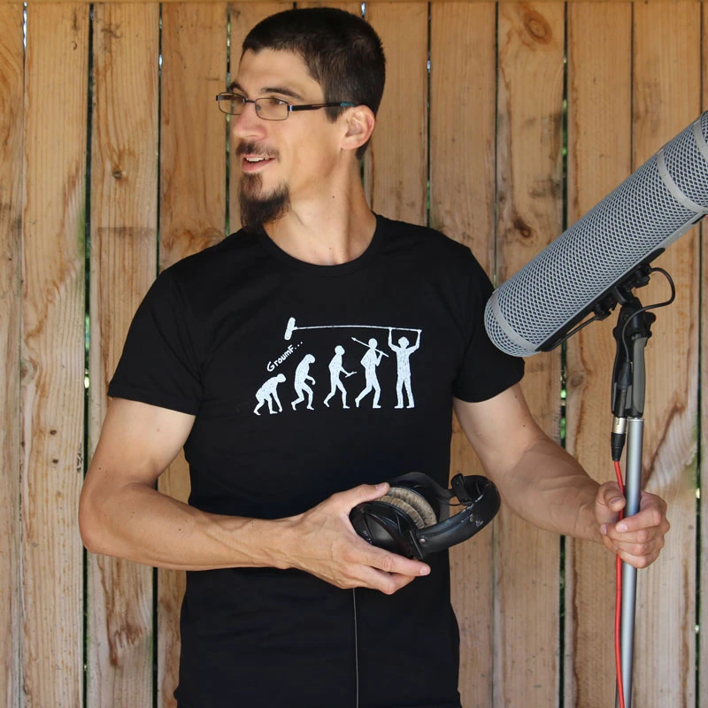 A boom operator with a mic and a boom pole